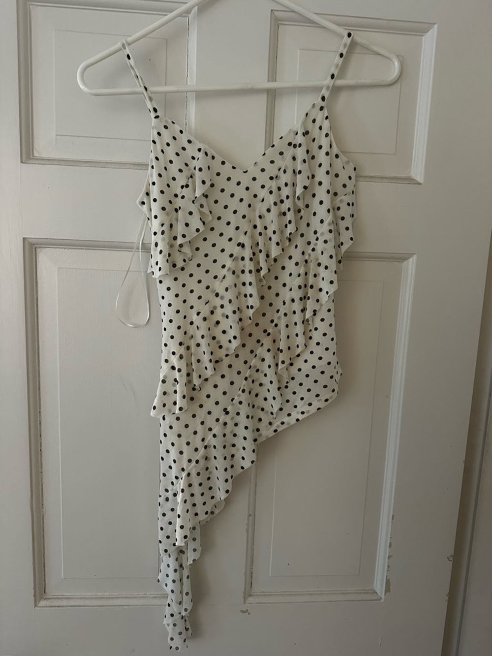 Black and white polka dot asymmetrical tank with ruffle